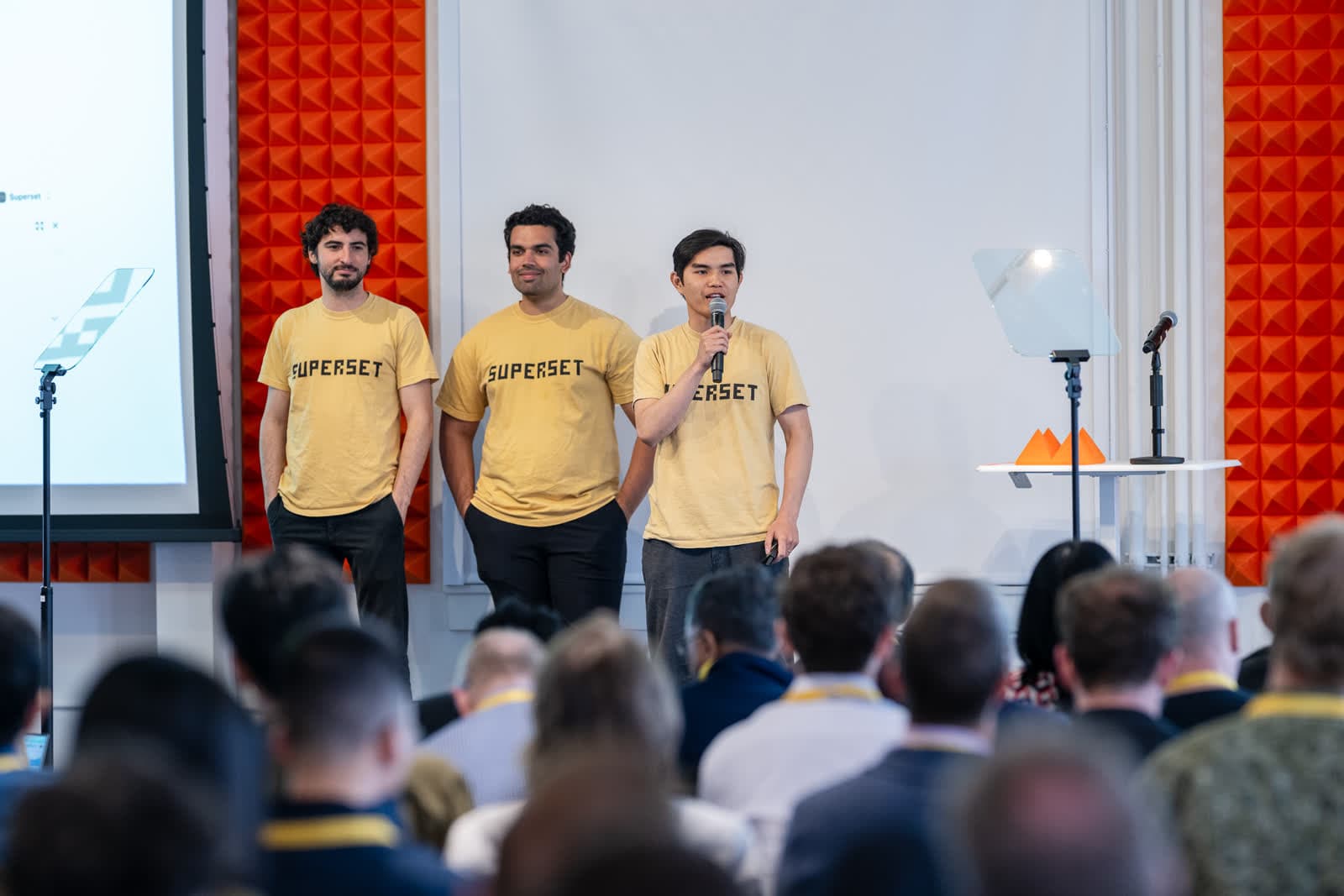 Avi, Satya, and Kiet on stage in Paradev shirts at Y Combinator Demo Day